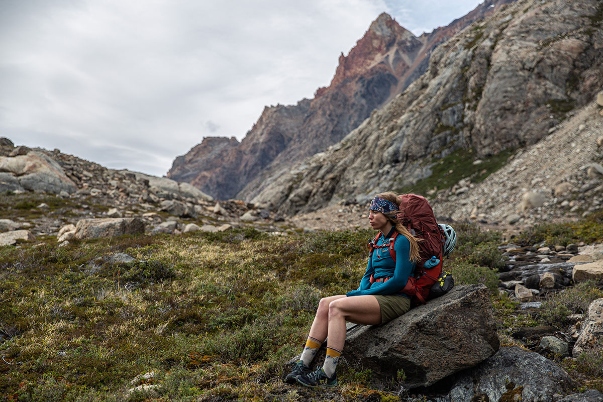 Women's hiking pants (sitting on rock in Patagonia Quandary shorts)